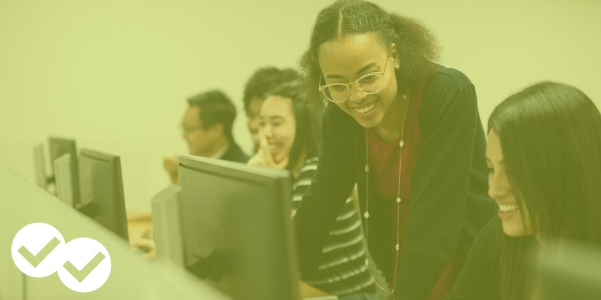 Teacher looks over student's computer